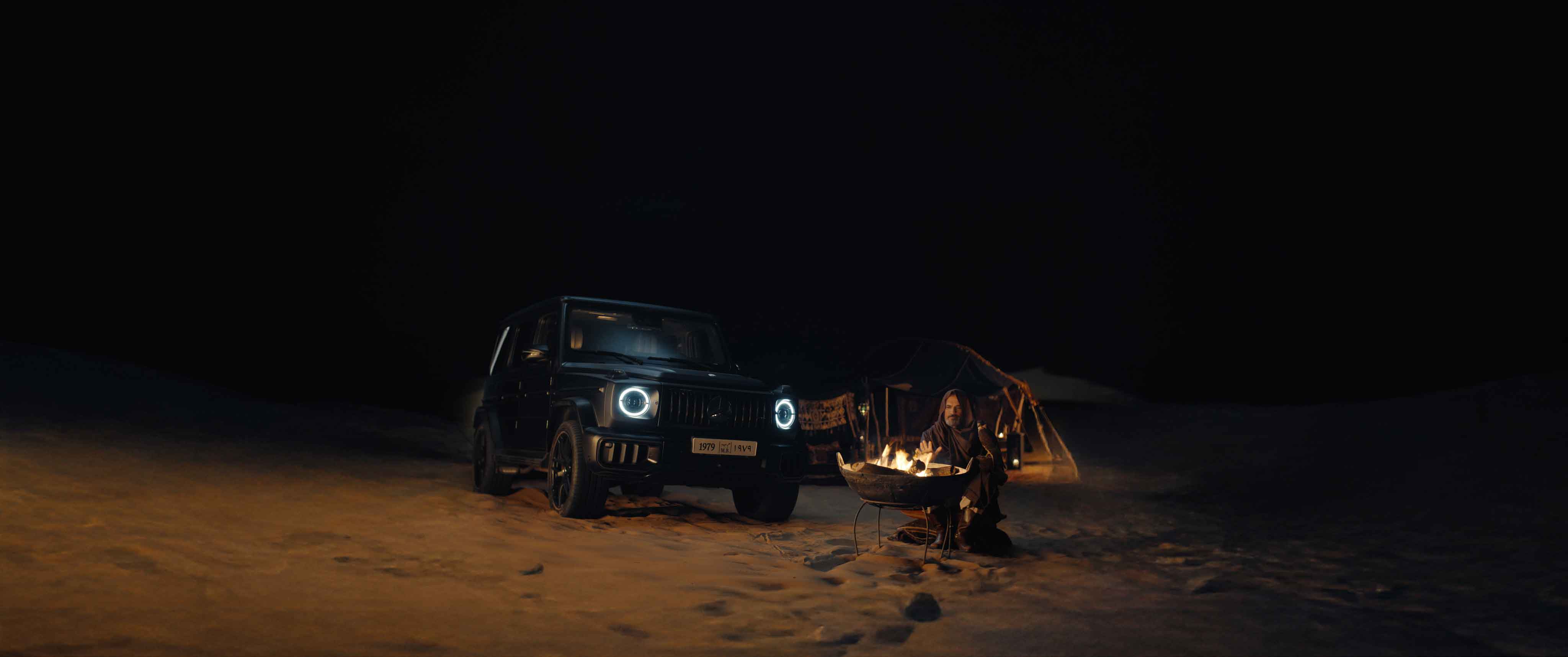 Mercedes G-Class parked in the Moroccan desert at night with a nomad by a fire – Farid Malki Ramadan film